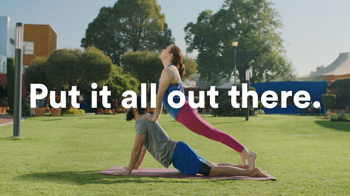 Man and woman doing yoga with the text - put it all out there