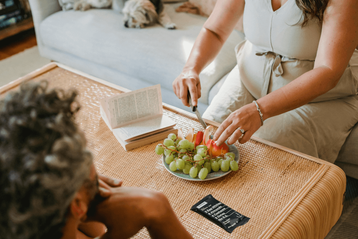 couple sharing gluten free snacks of grapes and apples
