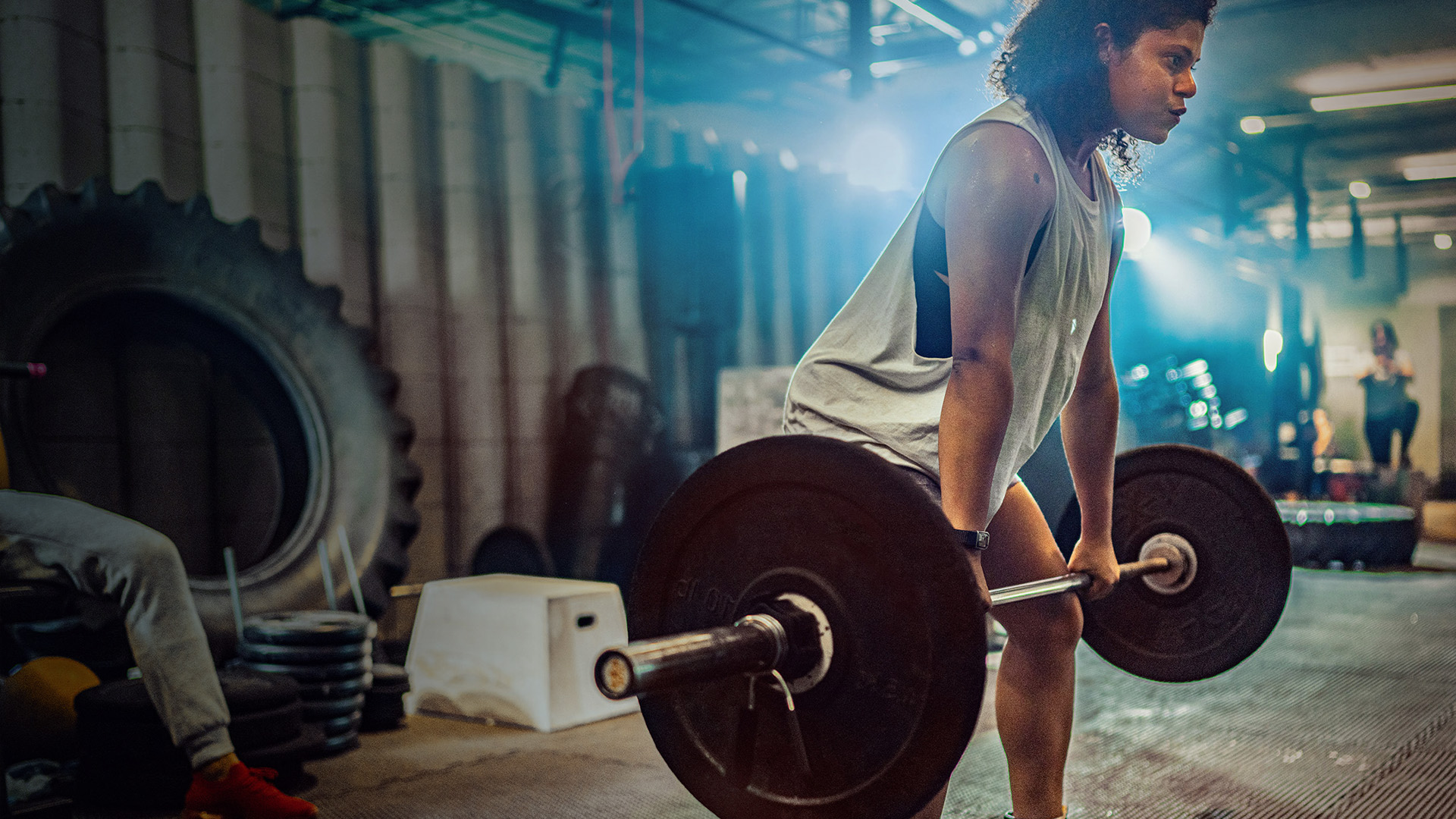 A woman in a gym lifting weights