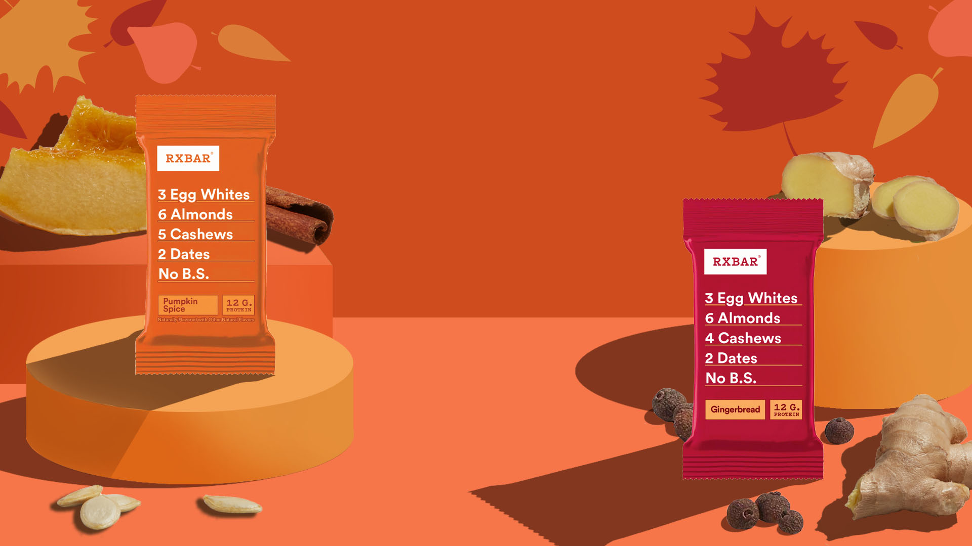 Pumpkin Spice and Gingerbread RXBARs on an orange background with leaves, pumpkin, cinnamon, ginger and allspice